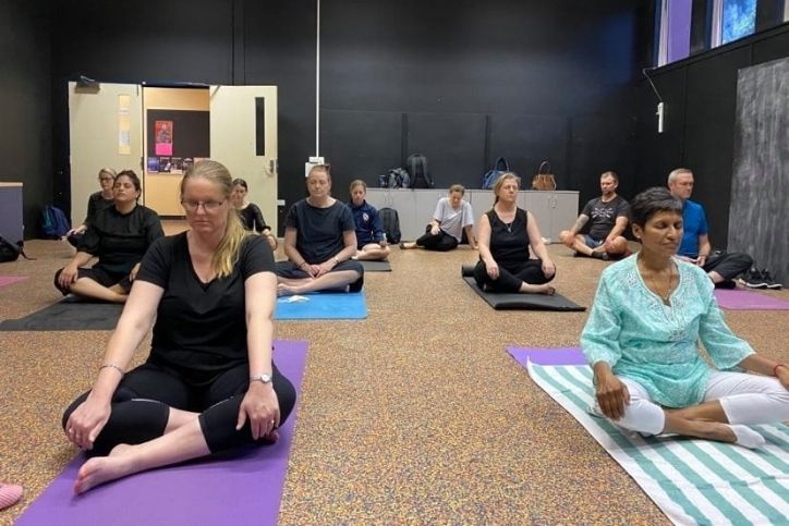 A group of employee at Kelvin Grove doing corporate yoga - Haven Yoga and Meditation
