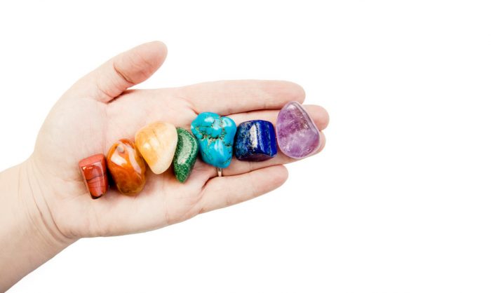 iStock-1180150756 Close up View of Woman Healer Hand Showing All Seven Chakra Color Crystal Stones in Color Order - Haven Yoga and Meditation Blog Image