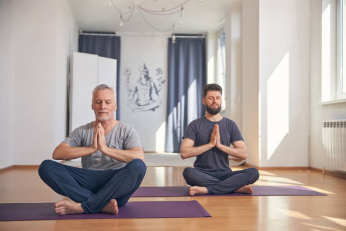 5 Reasons Men Should Practice Yoga and Meditation Two men doing yoga - Haven Yoga and Meditation