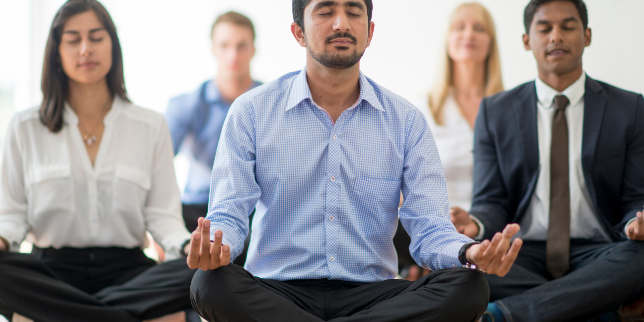 Yoga for Business Company employees meditating in a room - Haven Yoga and Meditation blog image