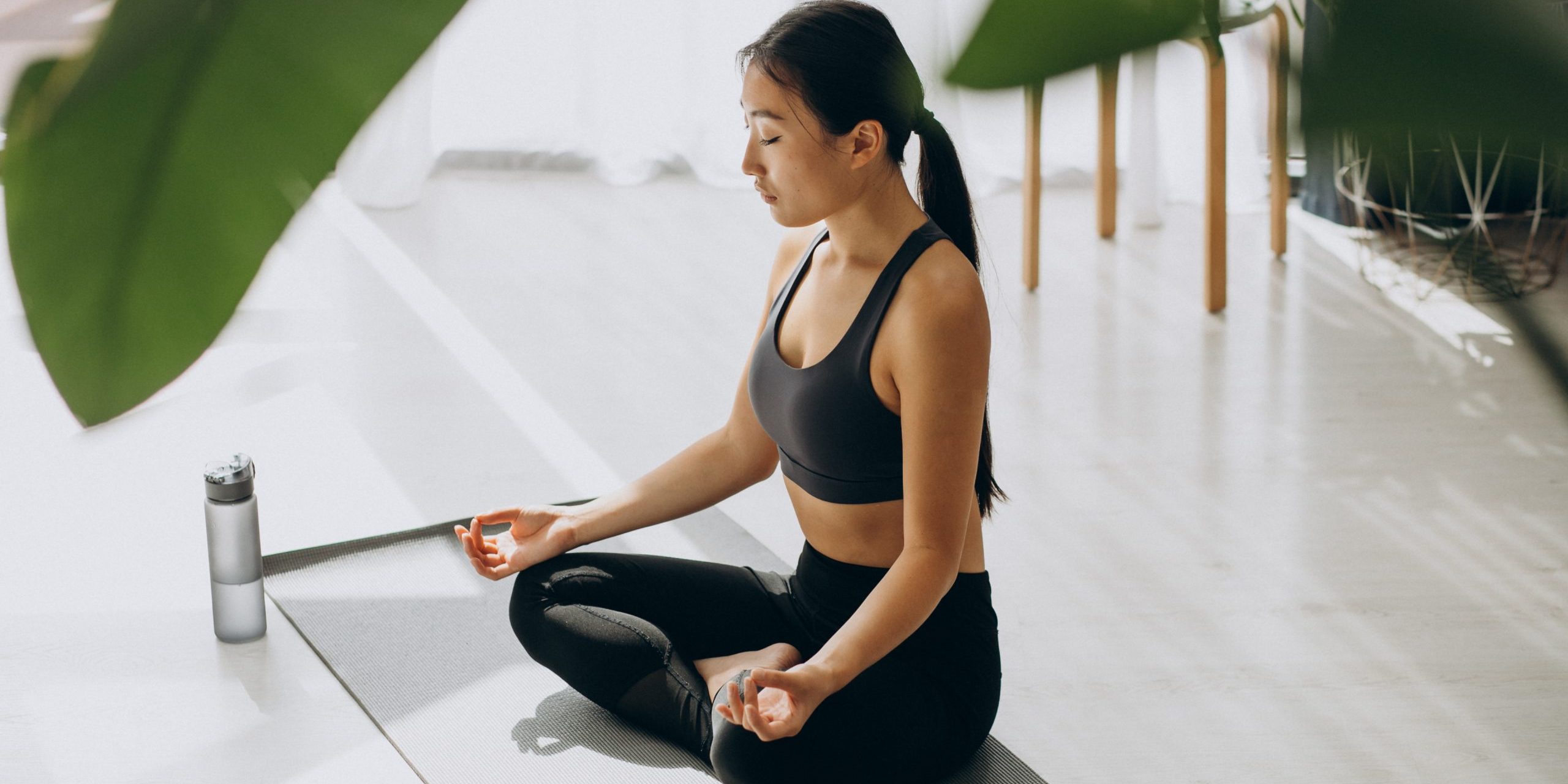 Woman practicing yoga on mat at home Kundalini Yoga
