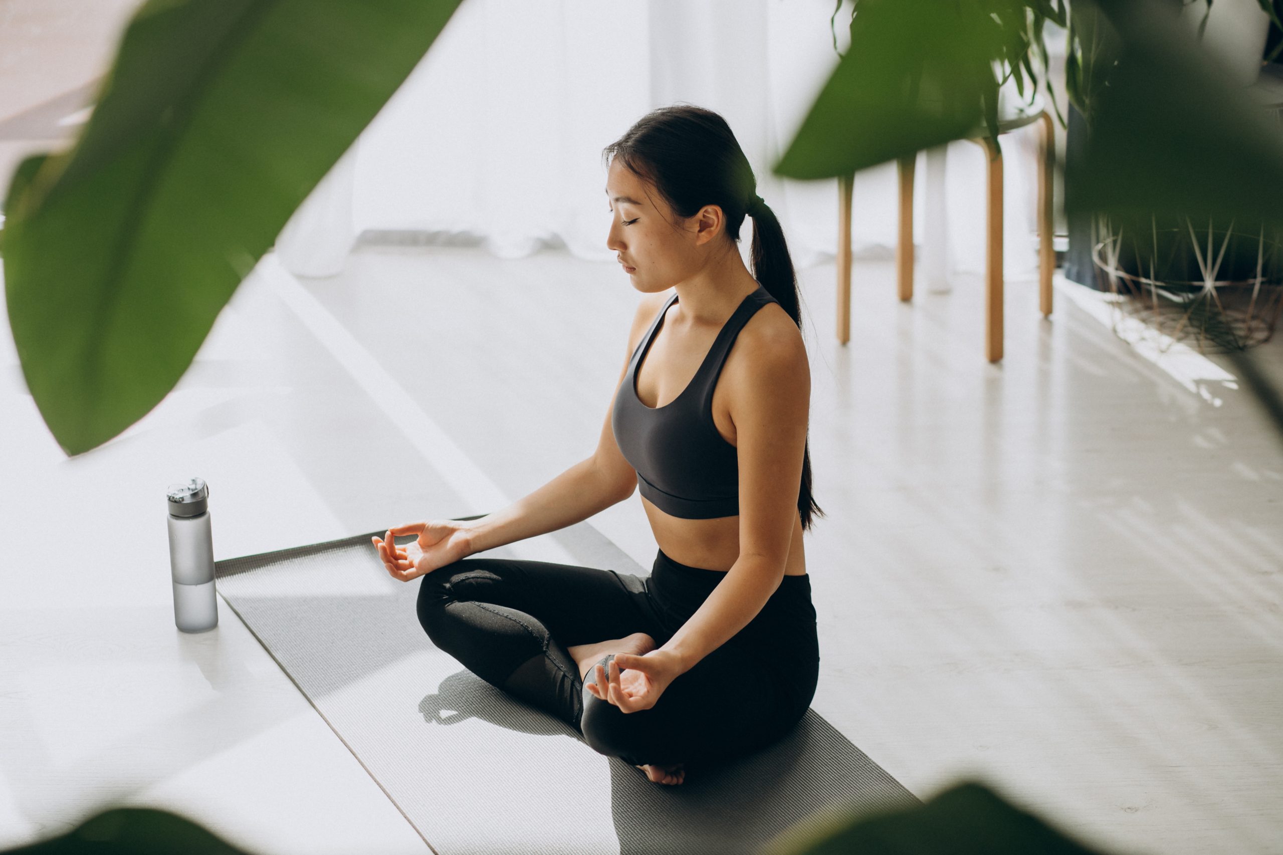 Woman practicing yoga on mat at home Kundalini Yoga